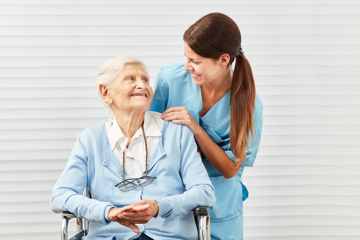caretaker helping elderly woman